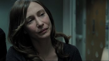 Movie still from “Orphan” (2009), directed by Jaume Collet-Serra – A person with long brown hair; Close Up shot, Over the shoulder angle