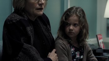Movie still from “Orphan” (2009), directed by Jaume Collet-Serra – An older woman and a young girl standing next to each other; Close Up shot, Over the shoulder angle