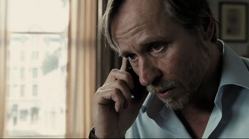 Movie still from “Orphan” (2009), directed by Jaume Collet-Serra – A person talking on a cell phone; Close Up shot, Low angle