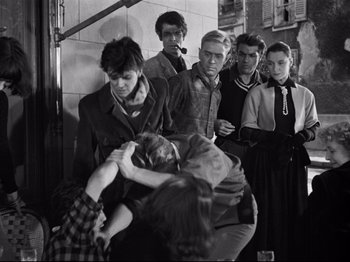 Movie still from “Orpheus” (1950), directed by Jean Cocteau – A group of people standing next to each other; Medium shot, High angle