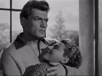 Movie still from “Orpheus” (1950), directed by Jean Cocteau – A man and a woman in a black and white photo; Medium shot, Low angle