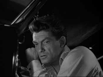 Movie still from “Orpheus” (1950), directed by Jean Cocteau – Black and white photograph of a man in a car; Close Up shot, High angle
