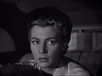 Movie still from “Orpheus” (1950), directed by Jean Cocteau – An old photo of an older woman in a white shirt; Close Up shot, Low angle