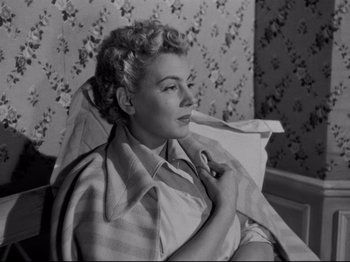 Movie still from “Orpheus” (1950), directed by Jean Cocteau – An old photo of a woman sitting on a couch; Medium shot, High angle