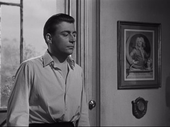 Movie still from “Orpheus” (1950), directed by Jean Cocteau – A black and white photo of a man standing in front of a door; Medium shot, Low angle