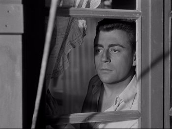 Movie still from “Orpheus” (1950), directed by Jean Cocteau – A black and white photo of a man looking out of a window; Close Up shot, Low angle