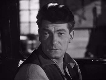 Movie still from “Orpheus” (1950), directed by Jean Cocteau – Black and white photograph of a man in a sweater; Close Up shot, High angle