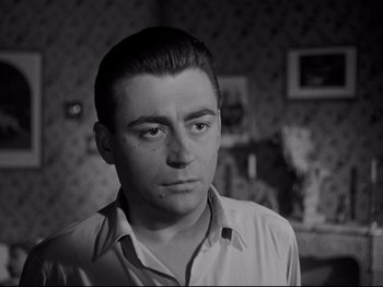 Movie still from “Orpheus” (1950), directed by Jean Cocteau – Black and white photograph of a man looking at the camera; Close Up shot, Low angle