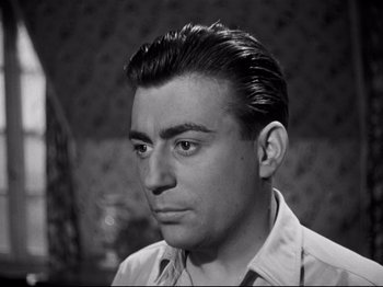 Movie still from “Orpheus” (1950), directed by Jean Cocteau – A black and white photo of a man with a goatee; Close Up shot, Low angle