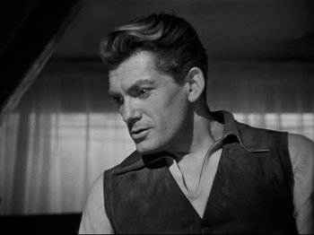 Movie still from “Orpheus” (1950), directed by Jean Cocteau – Black and white photograph of a man in a vest looking to his left; Close Up shot, Low angle