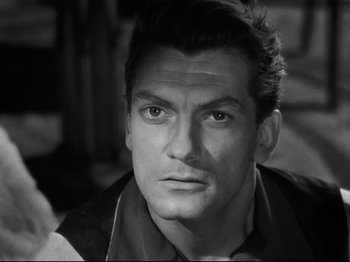 Movie still from “Orpheus” (1950), directed by Jean Cocteau – Black and white photograph of a man with a serious look on his face; Close Up shot, High angle