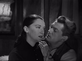 Movie still from “Orpheus” (1950), directed by Jean Cocteau – A man and a woman looking into each others eyes; Medium shot, Over the shoulder angle