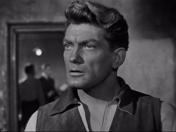 Movie still from “Orpheus” (1950), directed by Jean Cocteau – An old black and white photo of a man; Close Up shot, Over the shoulder angle