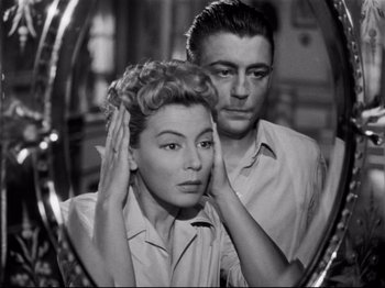 Movie still from “Orpheus” (1950), directed by Jean Cocteau – A man and a woman looking in a mirror; Close Up shot, High angle