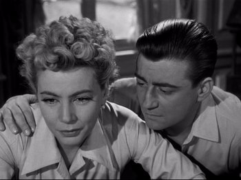 Movie still from “Orpheus” (1950), directed by Jean Cocteau – A man and a woman sitting next to each other; Close Up shot, High angle