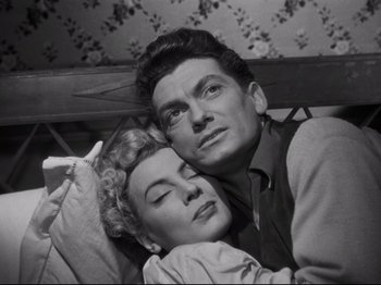 Movie still from “Orpheus” (1950), directed by Jean Cocteau – A man and a woman laying next to each other on a bed; Medium shot, High angle