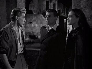 Movie still from “Orpheus” (1950), directed by Jean Cocteau – A group of men standing next to each other; Medium shot, Low angle