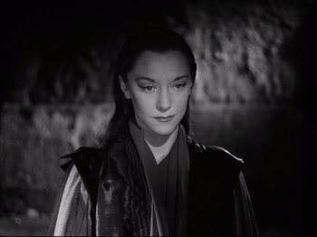 Movie still from “Orpheus” (1950), directed by Jean Cocteau – A young woman in a black and white photo; Close Up shot, High angle