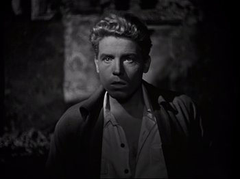 Movie still from “Orpheus” (1950), directed by Jean Cocteau – Black and white photograph of a man in a jacket; Close Up shot, Low angle