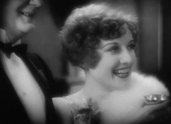 Movie still from “Our Dancing Daughters” (1928), directed by Harry Beaumont – An old black and white photo of a woman smiling; Close Up shot, High angle