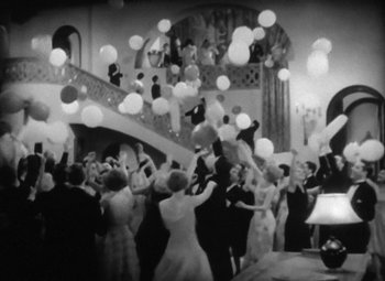 Movie still from “Our Dancing Daughters” (1928), directed by Harry Beaumont – A black and white photo of people at a party; Extreme Wide shot, Low angle