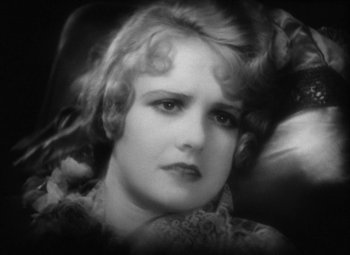 Movie still from “Our Dancing Daughters” (1928), directed by Harry Beaumont – An old black and white photo of a woman; Close Up shot, High angle