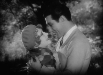 Movie still from “Our Dancing Daughters” (1928), directed by Harry Beaumont – An old photo of a man holding a child; Medium shot, High angle
