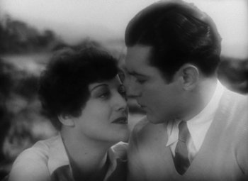 Movie still from “Our Dancing Daughters” (1928), directed by Harry Beaumont – A man and a woman are kissing each other; Close Up shot, High angle
