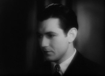Movie still from “Our Dancing Daughters” (1928), directed by Harry Beaumont – A black and white photo of a man in a suit and tie; Close Up shot, High angle