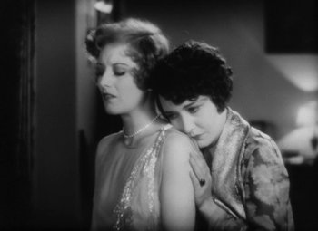 Movie still from “Our Dancing Daughters” (1928), directed by Harry Beaumont – A couple of women standing next to each other; Close Up shot, High angle
