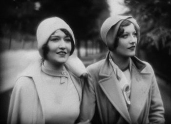 Movie still from “Our Dancing Daughters” (1928), directed by Harry Beaumont – A couple of women standing next to each other; Close Up shot, Low angle