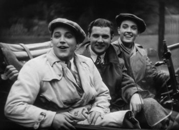 Movie still from “Our Dancing Daughters” (1928), directed by Harry Beaumont – A group of young men sitting on a park bench; Medium shot, Low angle