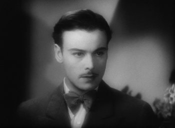 Movie still from “Our Dancing Daughters” (1928), directed by Harry Beaumont – A man in a suit and a bow tie; Close Up shot, High angle