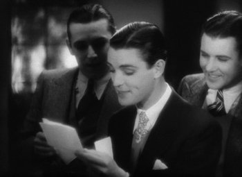 Movie still from “Our Dancing Daughters” (1928), directed by Harry Beaumont – A man in a suit and tie looking at a piece of paper; Medium shot, High angle