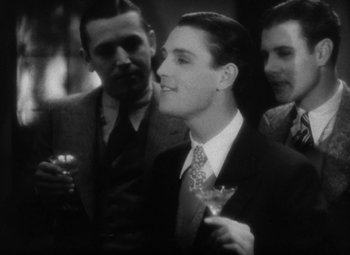 Movie still from “Our Dancing Daughters” (1928), directed by Harry Beaumont – A man in a suit and tie holding a wine glass; Medium shot, High angle