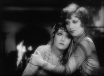 Movie still from “Our Dancing Daughters” (1928), directed by Harry Beaumont – A couple of women standing next to each other; Close Up shot, High angle