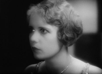 Movie still from “Our Dancing Daughters” (1928), directed by Harry Beaumont – An old photo of a young woman in a short dress; Close Up shot, High angle