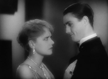 Movie still from “Our Dancing Daughters” (1928), directed by Harry Beaumont – A man and a woman standing next to each other; Close Up shot, High angle