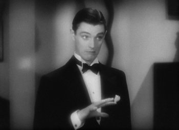 Movie still from “Our Dancing Daughters” (1928), directed by Harry Beaumont – A black and white photo of a man in a tuxedo; Close Up shot, High angle