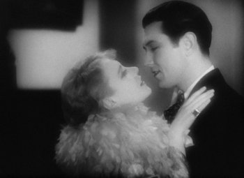 Movie still from “Our Dancing Daughters” (1928), directed by Harry Beaumont – A man and a woman are looking into each others eyes; Close Up shot, High angle
