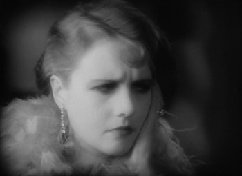 Movie still from “Our Dancing Daughters” (1928), directed by Harry Beaumont – A black and white photo of a woman's face; Close Up shot, High angle