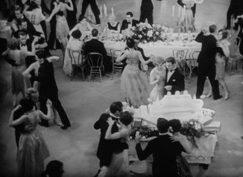 Movie still from “Our Dancing Daughters” (1928), directed by Harry Beaumont – A black and white photo of people dancing at an event; Wide shot, High angle