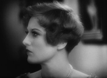 Movie still from “Our Dancing Daughters” (1928), directed by Harry Beaumont – A black and white photo of a woman's face; Close Up shot, Over the shoulder angle