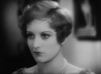 Movie still from “Our Dancing Daughters” (1928), directed by Harry Beaumont – An old photo of a woman in a dress; Close Up shot, High angle