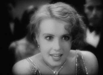 Movie still from “Our Dancing Daughters” (1928), directed by Harry Beaumont – An old photo of a young woman in a dress; Close Up shot, High angle