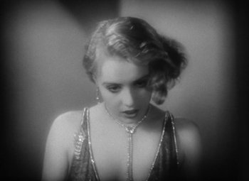 Movie still from “Our Dancing Daughters” (1928), directed by Harry Beaumont – A black - and - white photo of a woman in a dress; Close Up shot, High angle
