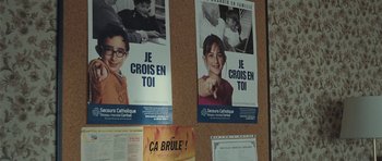 Movie still from “Our Day Will Come” (2010), directed by Romain Gavras – A bulletin board with posters of children on it; Close Up shot, High angle