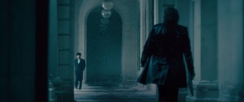 Movie still from “Our Kind of Traitor” (2016), directed by Susanna White – A man standing in front of an archway in the dark; Wide shot, Low angle