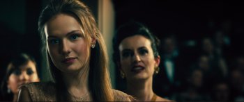 Movie still from “Our Kind of Traitor” (2016), directed by Susanna White – Two women standing next to each other in front of a mirror; Close Up shot, Over the shoulder angle