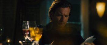 Movie still from “Our Kind of Traitor” (2016), directed by Susanna White – A man sitting in front of a glass of wine; Close Up shot, Low angle